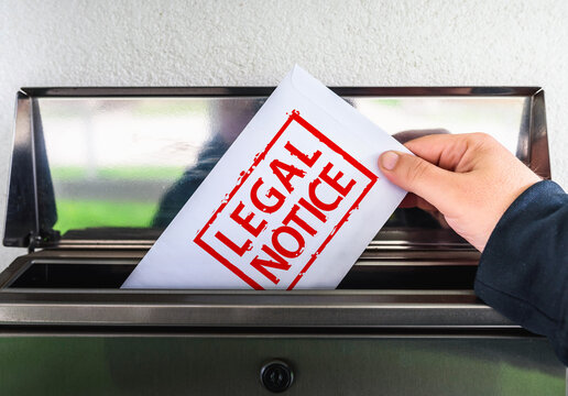 Hand Putting Legal Notice Envelope into Mailbox