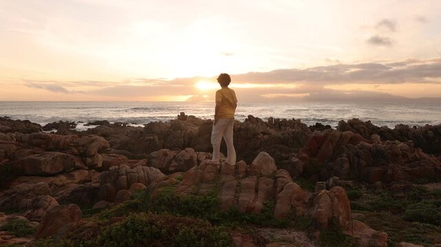 young boy exploring rocky coastline of DeKelders, Gansbaai, South Africa