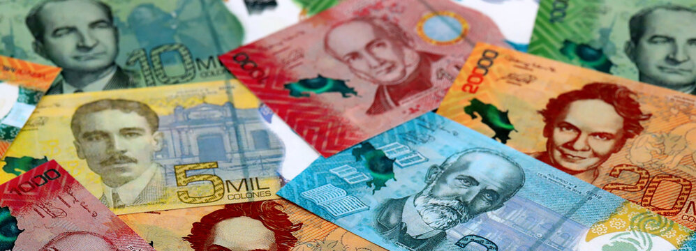 Costa Rican new colon money banknotes pile on table. Costa Rica bills of CRC currency close up