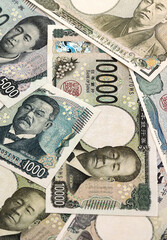 Japanese yen money banknotes pile on table. Japan bills of JPY currency. Concept of economy © Larysa