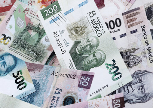 Mexican peso money banknotes pile on table. Mexico bills of MXN currency close up
