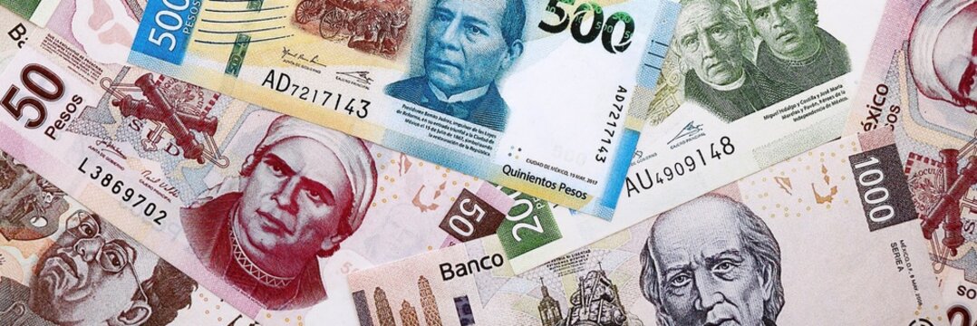Mexican peso money banknotes pile on table. Mexico bills of MXN currency close up
