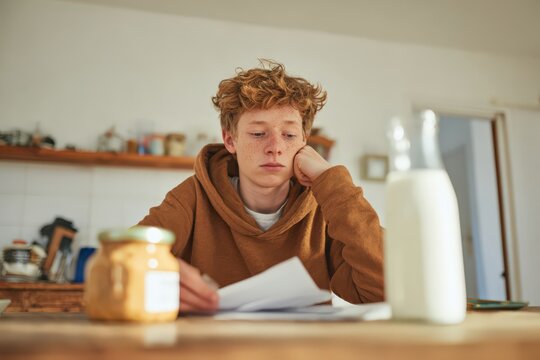 Boy examines ingredient label for peanut butter while feeling concerned about potential allergies at home during a morning routine