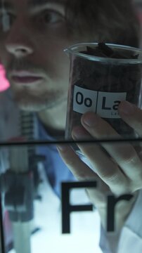 Dubai, UAE - 07 07 2025: Scientist examining chemicals in lab with test tube and beaker close-up
