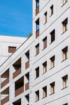 Angled balconies pull upward across a Lyon France apartment building facade, linking windows with residential architecture and urban depth