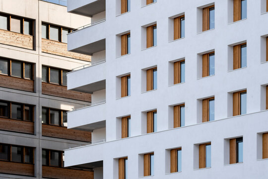 Layered balconies cross a Lyon France apartment building facade as windows organize residential architecture into calm urban geometry