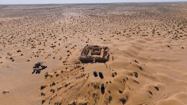 Aerial drone robot around the ancient Tisavar Fort ruins near Ksar Ghilane Oasis in the Tunisian Sahara Desert. Historical Roman outpost