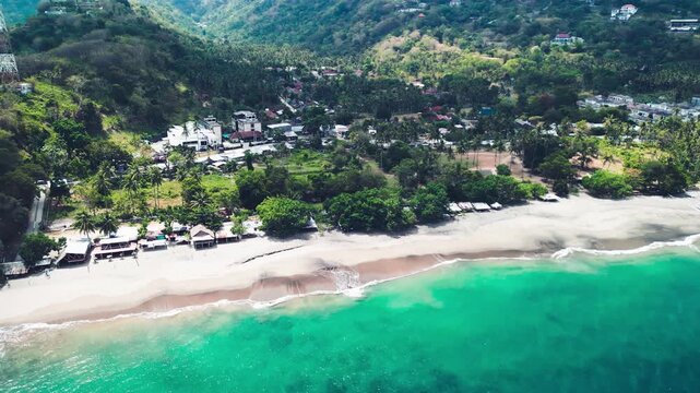 Drone perspective of Batu Bolong temple with ocean waves and coastal scenery Lombok