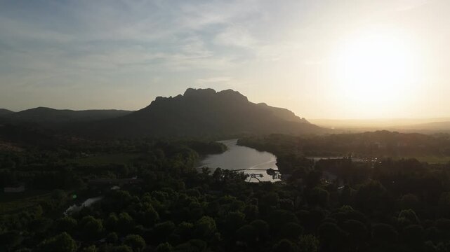 Aerial rising shot of Rocher de Roquebrune Mountain and River at Golden hour