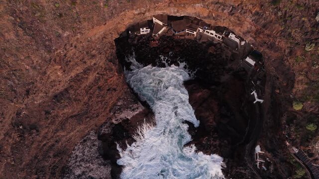 Village hidden in coastal cave Por&iacute;s de la Candelaria, La Palma, Spain, aerial top down view