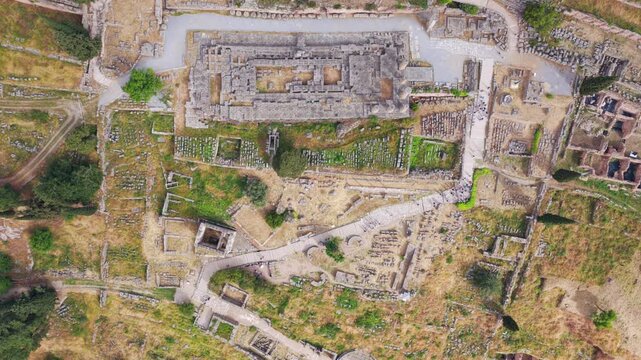 Amazing aerial top-down view of the archaeological site of Delphi, showing the temple of Apollo and the ancient theater, a significant Unesco world heritage site on mount Parnassus