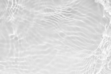 Fototapeta premium White water with ripples on the surface. Defocus blurred transparent white colored clear calm water surface texture with splashes and bubbles. Water waves with shining pattern texture background.