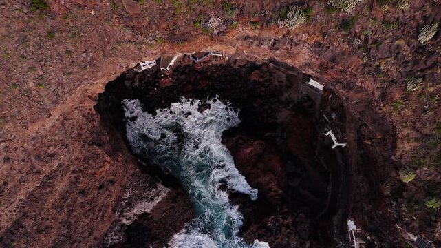 Aerial revealing view of Poris de la Candelaria stunning fisherman village hidden in coastal cave