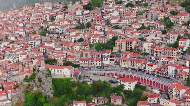 Majestic aerial view of the picturesque mountain town of Arachova in Greece, with its traditional houses with red tiled roofs climbing up the verdant slopes of mount Parnassus