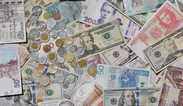 collage of different world paper currencies. Background of banknotes and different coins, Ukrainian hryvnia, US dollars, Polish zloty and Egyptian pounds. Financial background of banknotes and coins