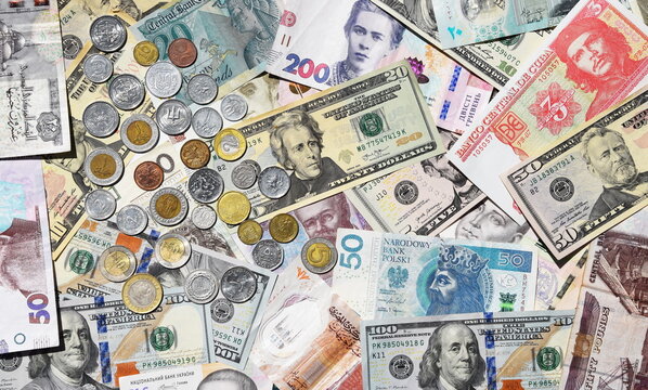 collage of different world paper currencies. Background of banknotes and different coins, Ukrainian hryvnia, US dollars, Polish zloty and Egyptian pounds. Financial background of banknotes and coins