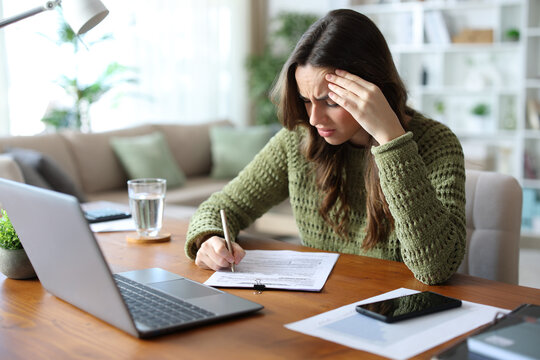 Worried teleworker filling out form or doint test