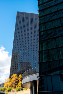 Blue sky sharpens the glass skyscraper edges of La Defense Paris France, placing business district architecture within urban autumn detail