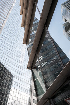 Glass towers converge above La Defense Paris France, turning business district architecture and urban structure into a vertical sky view