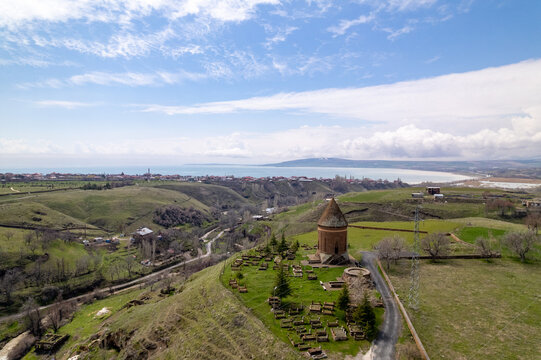 Historic Hasan Padisah Kumbet in Ahlat, Bitlis, T&uuml;rkiye, overlooking Lake Van and surrounding medieval cemetery landscape with monumental Seljuk architecture.