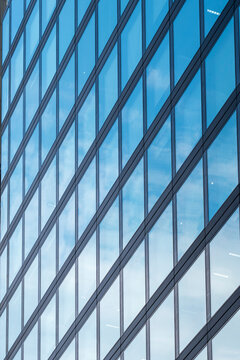 Blue glass lines repeat across Frankfurt Germany office facade, making business district architecture feel abstract and urban