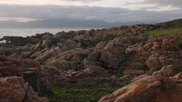 rocky coastline of DeKelders, Gansbaai, South Africa at sunset