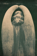 Fototapeta premium Lonely angel statue with hidden face and folded wings, symbolic image of mourning, silence and eternal grief
