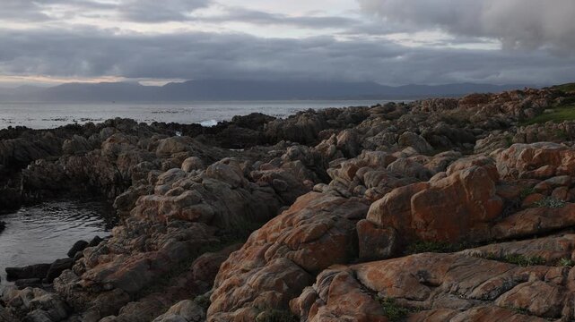 rocky coastline of DeKelders, Gansbaai, South Africa at sunset