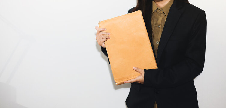 female lawyer in suit at workplace with laptop, gavel and femida in office