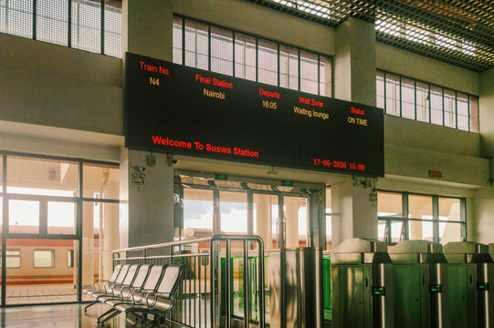Interior of Suswa SGR Station with Departure Board, Waiting Lounge Seats, and Ticket Turnstiles, Kenya