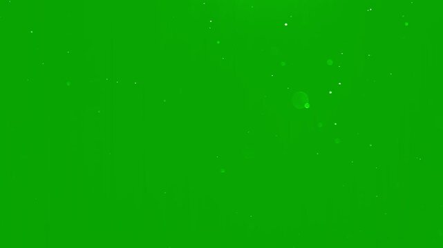 Beautiful slow motion snow dust with soft light particles on a green background. Perfect for Christmas visual, winter intro, cinematic overlay, motion design project. White snowflakes falling isolated