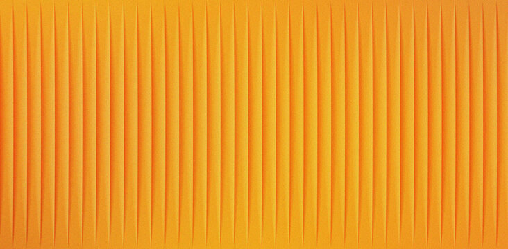 Abstract close up of vibrant textured orange vertical stripe pattern background demonstrating a rhythmic three dimensional geometric surface design on white background