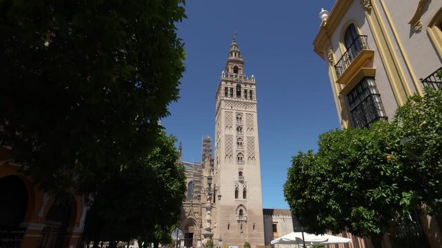Handheld walking shot of Giralda tower in Seville old town Spain