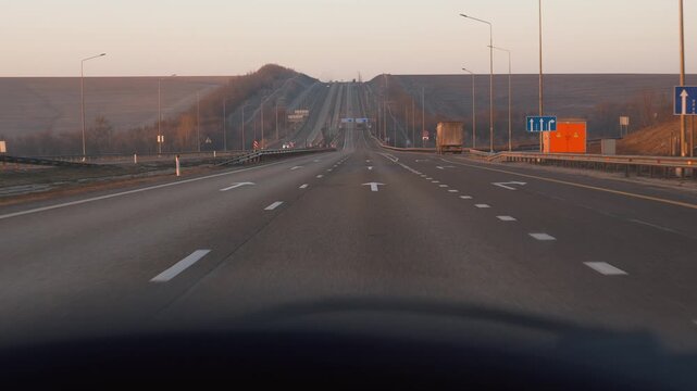 First-person perspective driving along the m-4 don federal highway in russia during the early morning hours, with road signs pointing towards rostov-on-don and moscow in cyrillic