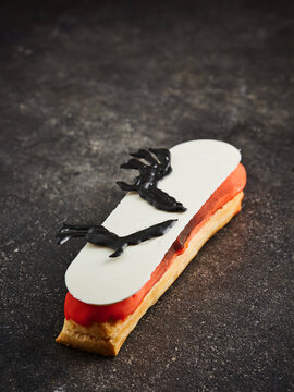 This is a gourmet dessert pastry featuring a fruit filling topped with a chocolate design. Ideal for high-end restaurant menus, catering events, or modern dessert displays