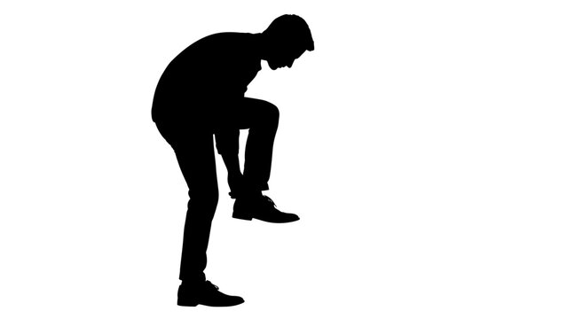 Man bending over in silhouette form.
