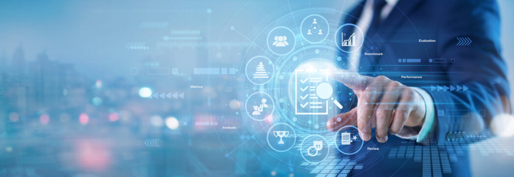 Human resources manager. Corporate evaluation officer touching Assessment virtual screen to evaluate employee performance metrics and track corporate skills growth. Talent development team.
