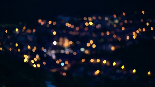 Blurred city lights transition to sharp night view of Brasov old town architecture in Romania.
