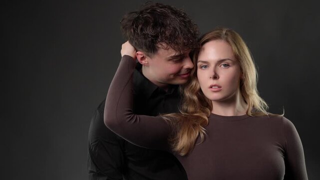 Emotional manipulation and control, showing a man whispering intently to a woman with her eyes closed, followed by her sudden shocked and fearful reaction. This footage is editorial content, documenta