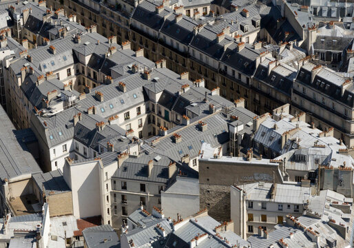 Paris rooftops, with zinc roofs, chimneys and dense urban pattern