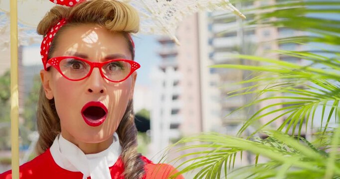 Pinup Style Woman Reacts with Surprise and Joy Under Parasol