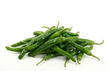Fototapeta premium Pile of fresh green chili peppers on white background