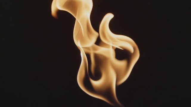 Rising single amber flame emerging below frame in dark studio, unfurling into ribbons, from drafts