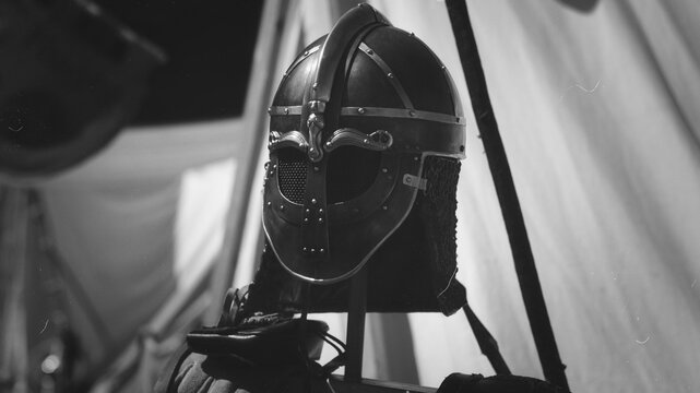 Historical Viking helmet with chain mail av entail on display stand