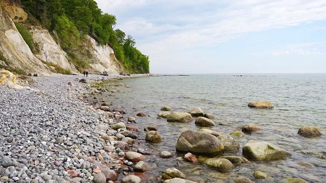 Famous white chalk cliffs and rocky Baltic Sea coastline in Jasmund National Park on Rugen island, Germany. Iconic natural landmark and coastal travel destination concept.