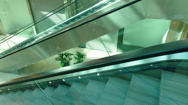 Empty escalators moving inside modern shopping mall interior. Retail commerce environment featuring sleek architecture automated transport and contemporary consumer space. Commercial center