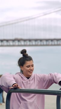Waterfront cooldown woman adjusting hair after workout