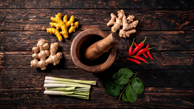 Explore the vibrant colors and textures of Indonesian spices like turmeric and ginger in this photorealistic flat lay image.