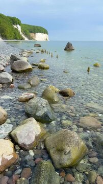 Famous white chalk cliffs and rocky Baltic Sea coastline in Jasmund National Park on Rugen island, Germany. Iconic natural landmark and coastal travel destination concept.