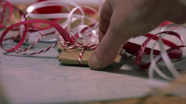 Hands with Christmas gift wrapped in string